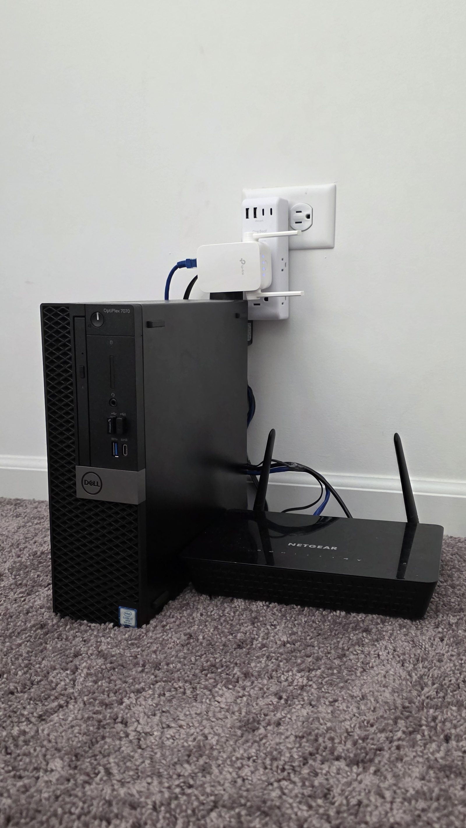 Homelab hardware: Dell OptiPlex 7070 SFF running Proxmox VE, Netgear R6220 running OpenWrt, and TP-Link RE750C WAN uplink